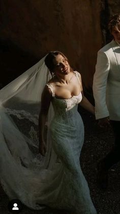 a bride and groom walking down the street