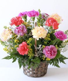 a basket filled with lots of different colored flowers