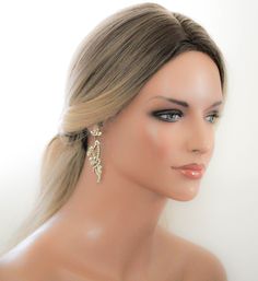 a female mannequin head with blonde hair and earrings