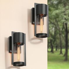 Incorporate modern sense into your living space with this uniquely 1-Light 11.5-in Matte Black Clear Glass Round Shade Outdoor Wall Light (Set of 2) by Uofin Lighting, safely rated for wet locations. The industrial outdoor wall sconce is the perfect combination of the industrial look and traditional in a typical modern style light fixture. The black lantern outdoor light fixture is a refined layered design, with a clear glass shade that flares at the bottom nested within a metal frame also the openwork design makes it easy to change bulbs. The overall look of this transitional lantern shape is classic and well-designed, with great lighting function and aesthetics. Not only for exterior outdoor locations such as garages, front doors, and entrances, this cage wall sconce is also a good choic Black Outdoor Wall Lights, Black Lantern, Led Outdoor Wall Lights, Outdoor Light Fixtures, Outdoor Wall Lantern, Wall Lantern, Outdoor Lanterns, Lantern Lights, Outdoor Wall