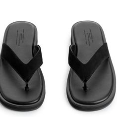 New With Tag Thong Sandals With A Chunkier Sole And A Wider Upper Strap. Sole Height 2 Cm. Composition Leather 100% Lining: Leather 100% Sole: Thermoplastic Rubber 100% Trendy Leather Platform Flip Flops, Modern Black Flip Flops With Textured Footbed, Modern Black Toe Post Sandals, Summer Flip Flops With Textured Sole, Summer Flip Flops With Textured Sole And Toe Post, Modern Textured Toe Post Flip Flops, Black Toe Post Sandals With Textured Sole, Leather Platform Flip Flops With Single Toe Strap, Black Single Toe Strap Flip Flops