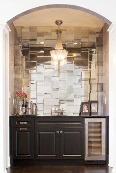 an instagramted photo of a bathroom with black cabinets and white tiles on the wall