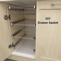 an open cabinet door showing the bottom shelf and bottom shelves with wire baskets in it