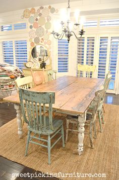 a dining room table with chairs and a chandelier