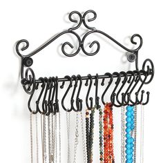 a rack with many different colored beads hanging from it's sides and hooks attached to the wall