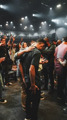 two men hugging each other in front of an audience