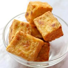 small pieces of bread sitting in a glass bowl