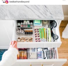 someone is holding the drawers open to show what's inside them and how they are organized