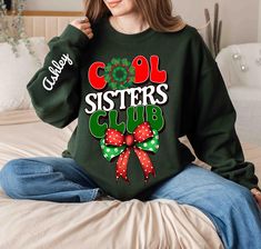 Custom Sister's Christmas Sweatshirt for matching Christmas outfits. This unisex jersey short sleeve tee is perfect for sisters looking to show off their bond with style. The lightweight fabric and retail fit make it suitable for both active and leisure wear, great for casual and semi-formal settings. Ideal for sisters celebrating Christmas together. Product features Care instructions - Machine wash: cold (max 30C or 90F) - Non-chlorine: bleach as needed - Tumble dry: low heat - Iron, steam or d Matching Family Christmas Shirts, Family Holiday Gifts, Matching Christmas Outfits, Sorority Shirt, Sister Christmas, Celebrating Christmas, Christmas Outfits, Family Christmas Shirts, Sorority Shirts