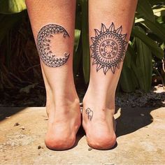 two sun and moon tattoos on both legs, one with an elephant in the middle