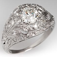 an antique style diamond ring with filigrees