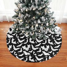 a black and white christmas tree skirt with bats on it