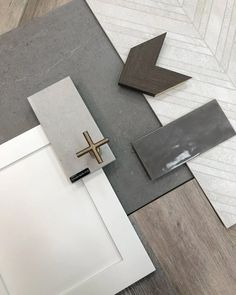 a cross on the floor next to some tile and wood planks in an area that looks like it is being remodeled