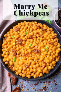 a bowl filled with chickpeas and topped with bacon