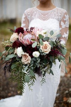 a bride holding a bouquet of flowers in her hands