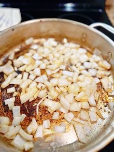 onions are being cooked in a pan on the stove