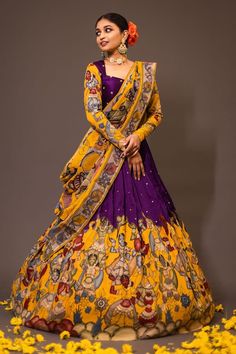 Purple base attached cancan lehenga with women kalamkari hand painted patterns and embroidery. Paired with padded purple blouse embroidered with glass beads and yellow printed dupatta. - Aza Fashions Kalmkari Pattern Lehenga, Full Hands Blouse Designs For Lehenga, Yellow And Purple Lehenga, Traditional Silk Lehenga Designs, Kalamkari Painting Saree, Kalamkari Lehangas Designs, Half Saree Lehenga Simple, Penkalamkari Lehanga, Kalamkari Half Saree Lehenga