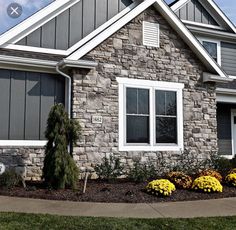 a house that has some flowers in front of it