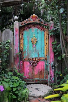 an old door is painted pink and blue