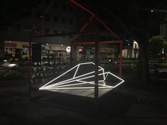 a lit display in the middle of a park at night