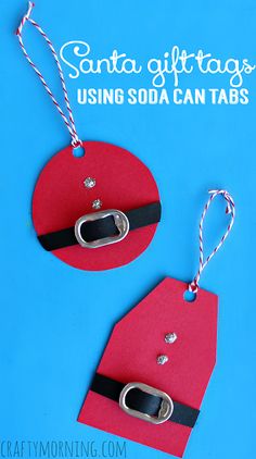 two red tags with black straps hanging from them on a blue background that says santa gift tags using soda can tabs