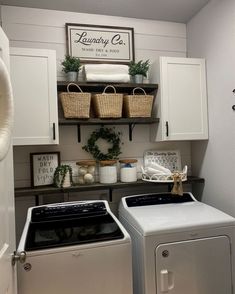 a white washer and dryer sitting next to each other in a laundry room