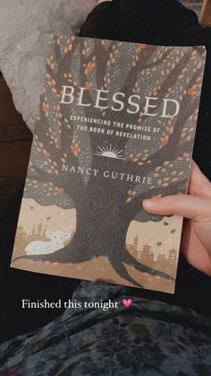 a person holding up a book in front of their face with the title, blessing