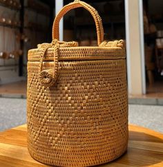 a woven basket sitting on top of a wooden table