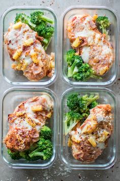 four plastic containers filled with different types of food and broccoli florets