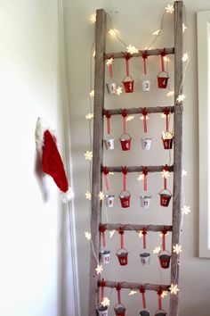 an old ladder is decorated with christmas lights and cupcakes for the holiday season