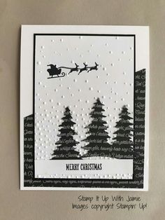 a handmade christmas card with santa's sleigh flying over the trees