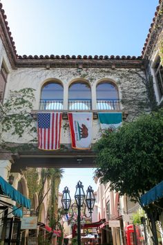 an archway with flags hanging from it's sides