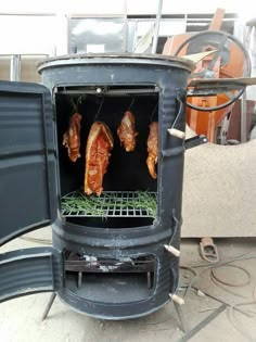 three meats are cooking on an outdoor charcoal stove with grill grates and wire