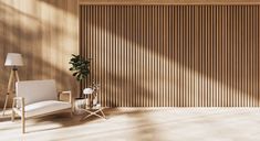 an empty room with a chair, lamp and potted plant on the floor in front of a wooden paneled wall