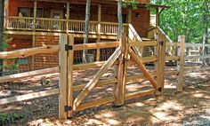 a wooden gate in front of a log cabin