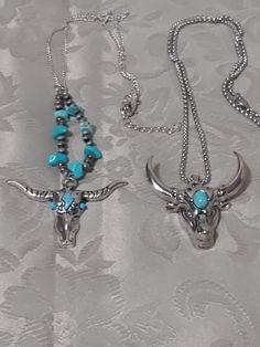 These silver and turquoise bull head necklaces are made in the western style of male accessories. The steer with the forehead and eyes of turquoise also has a 20" silver chain with turquoise nuggets. The steer with the large forehead stone has a 22" silver chain. Large Forehead, Male Accessories, Necklaces Long, Long Horn, Bull Head, Bull Skull, Native Style, Bull Skulls, Skull Necklace