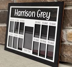 a black and white sign on the side of a brick wall that says harrison grey