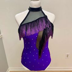 a woman's purple and black leotard with sequins on it