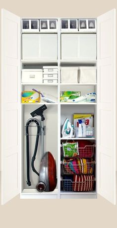 an open white closet with many items in it and storage bins on the shelves