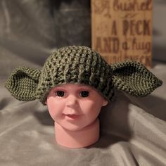 a doll with a knitted hat on it's head