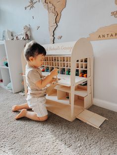 a little boy playing with toys in his room