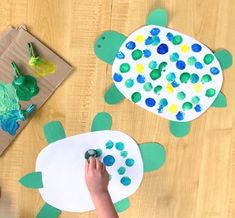 two children are making paper plates with sea animals