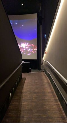 a long hallway leading to a large screen