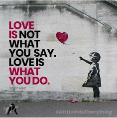 a painting on the side of a building that says love is not what you say, love is what you do