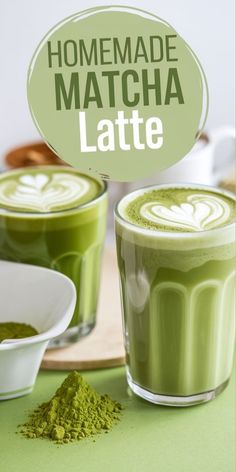 two cups filled with matcha latte on top of a table