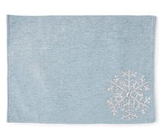 a light blue towel with white snowflakes on the front and back of it