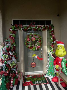 the grinch door is decorated with christmas wreaths and candy canes, as well as other holiday decorations