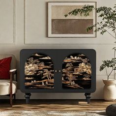 a black cabinet with two doors in front of a white couch and potted plant