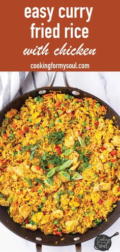 an easy curry fried rice dish with chicken in a cast iron skillet on a marble counter top