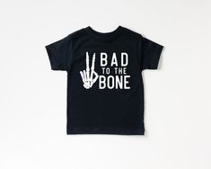 "Bad To The Bone, Baby Toddler or Youth T-Shirt, Kids Halloween Shirt, Baby Boy Halloween, Toddler Boy Halloween, Boy Halloween Shirt, Fall W H Y - S H O P - W I T H - S W E E T T C A P R I ? Thank you for stopping by! I'm Cassie and everything in my shop is made entirely by myself. I take pride in good quality, excellent customer service, and affordable prices. I use only Bella + Canvas t-shirts and you are sure to love them. They are soft and comfy for your little one. My products are made wit Boy Halloween Shirts, Boys Fall Shirts, Funny Kids Shirts Boys, Toddler Halloween Shirts, Halloween Shirts For Boys, Baby Boy Halloween, Funny Toddler Shirt, Funny Kids Shirts, Halloween Shirts Kids